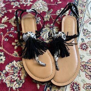 Tassel Frannie T-strap Sandals by GUESS